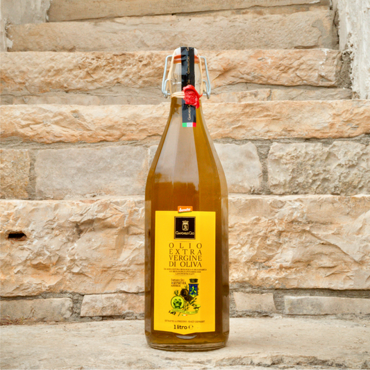 glass bottle of olive oil on a stone staircase