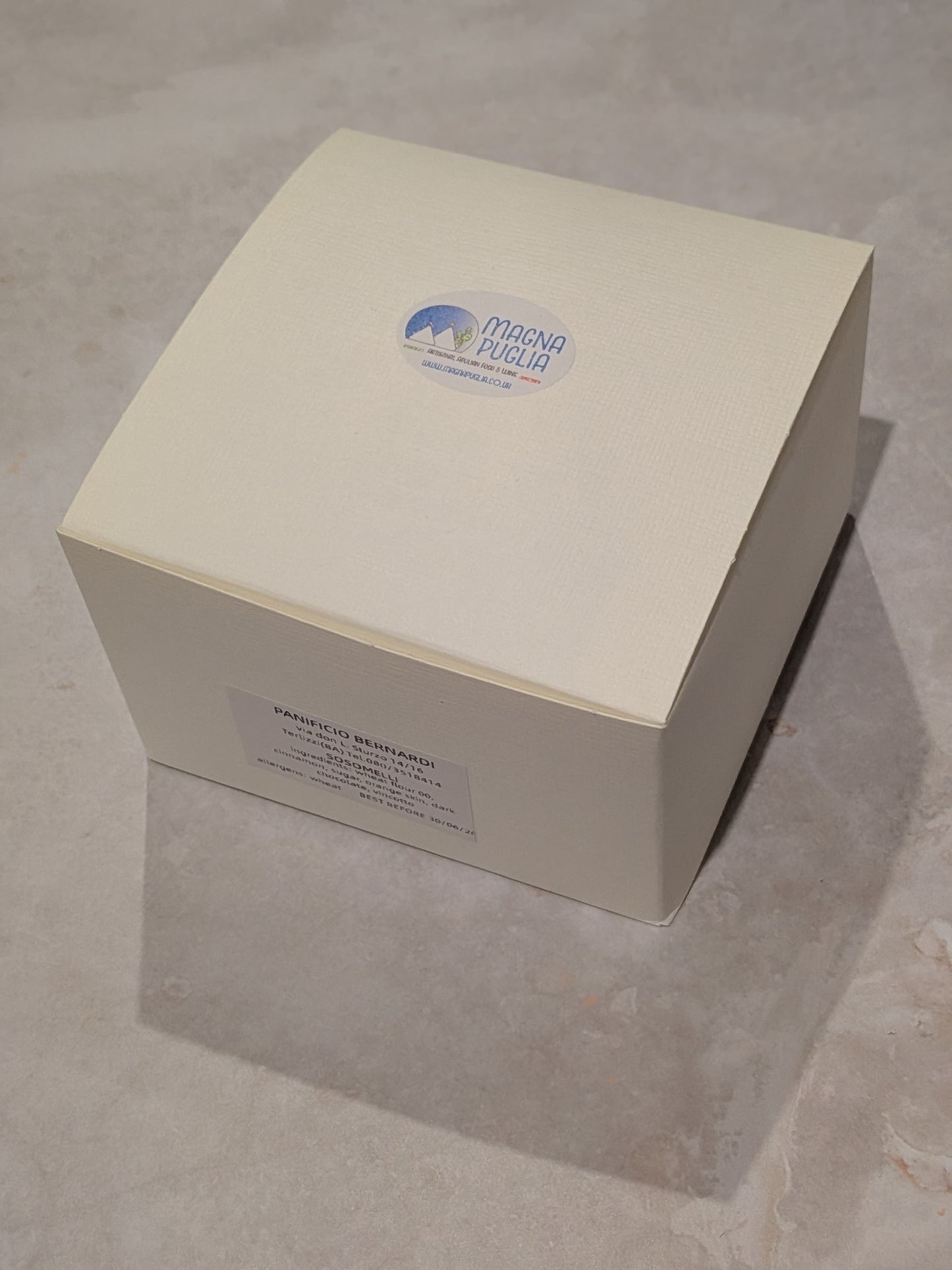 White box with a logo on a gray surface
