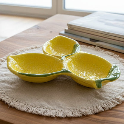 Yellow ceramic dish shaped like a lemon on a wooden table with books in the background