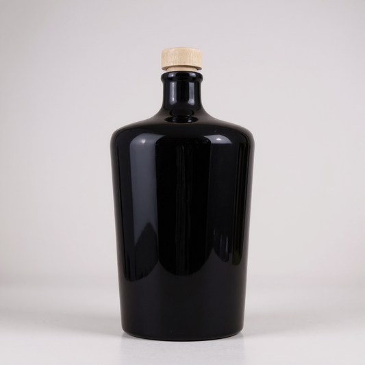 Black bottle with a cork on a white background