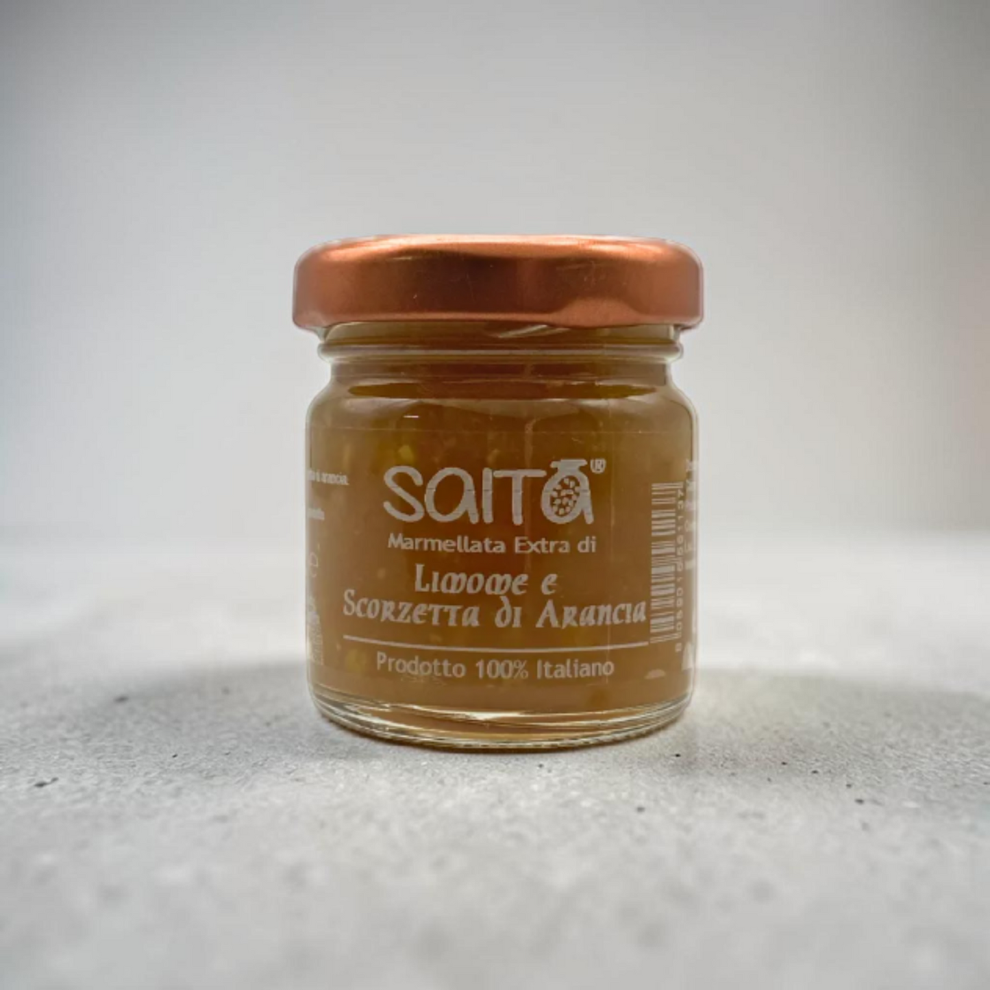 Jar of Saita marmellata on a gray background