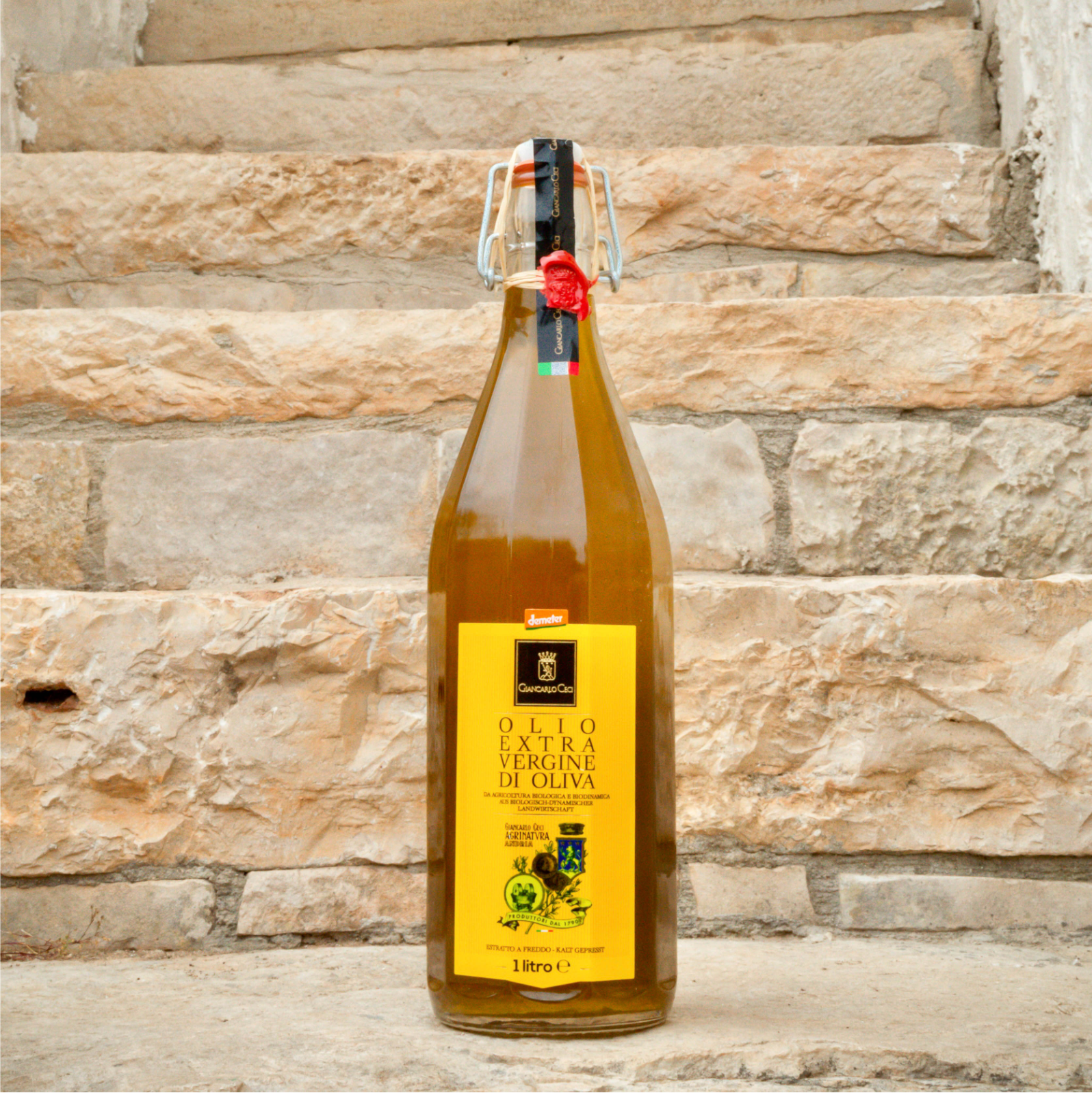 glass bottle of olive oil on a stone staircase