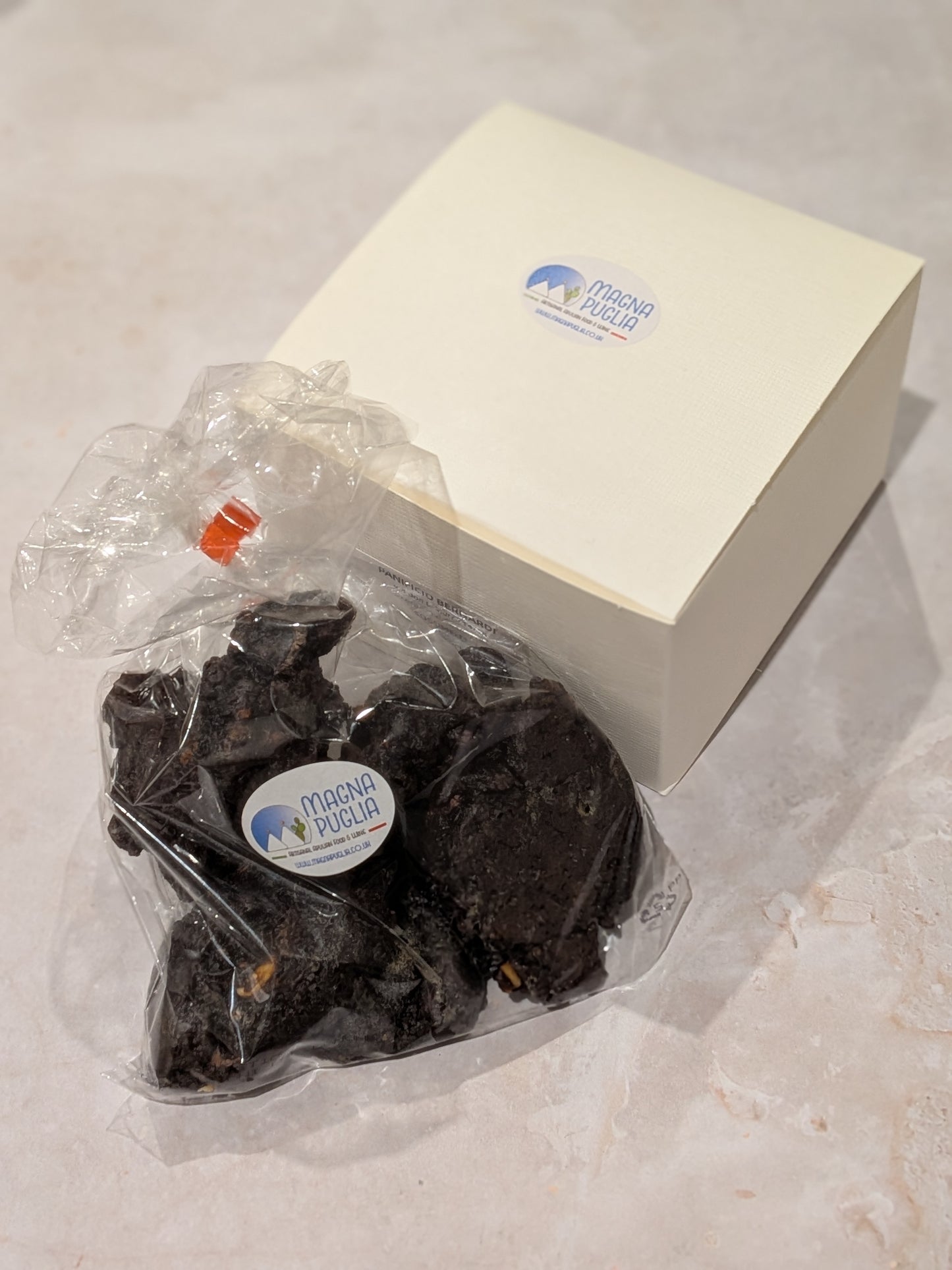 Packaged chocolate biscuits with a branded label on a white surface