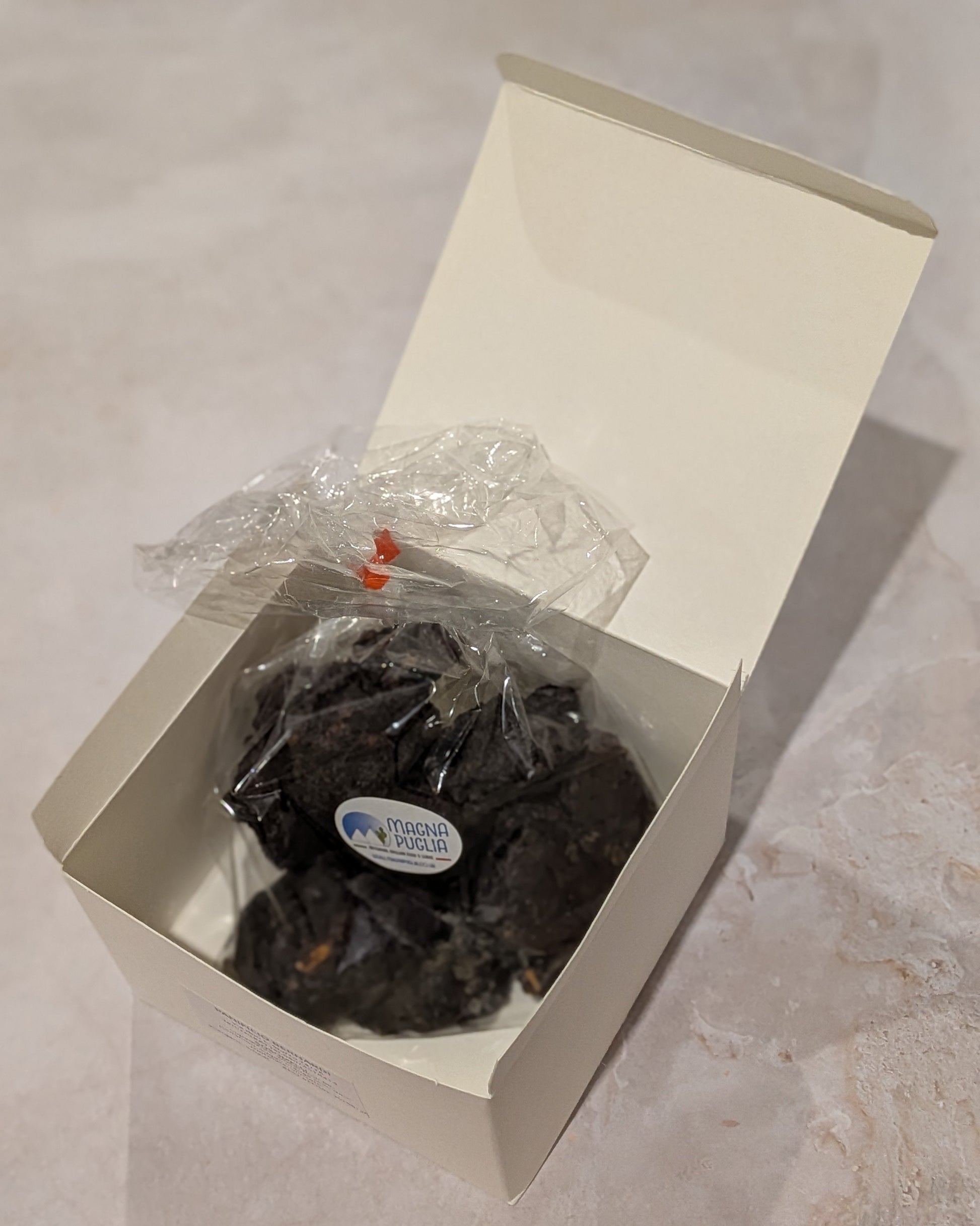 Box of chocolate biscuits with a visible brand label on a light surface.